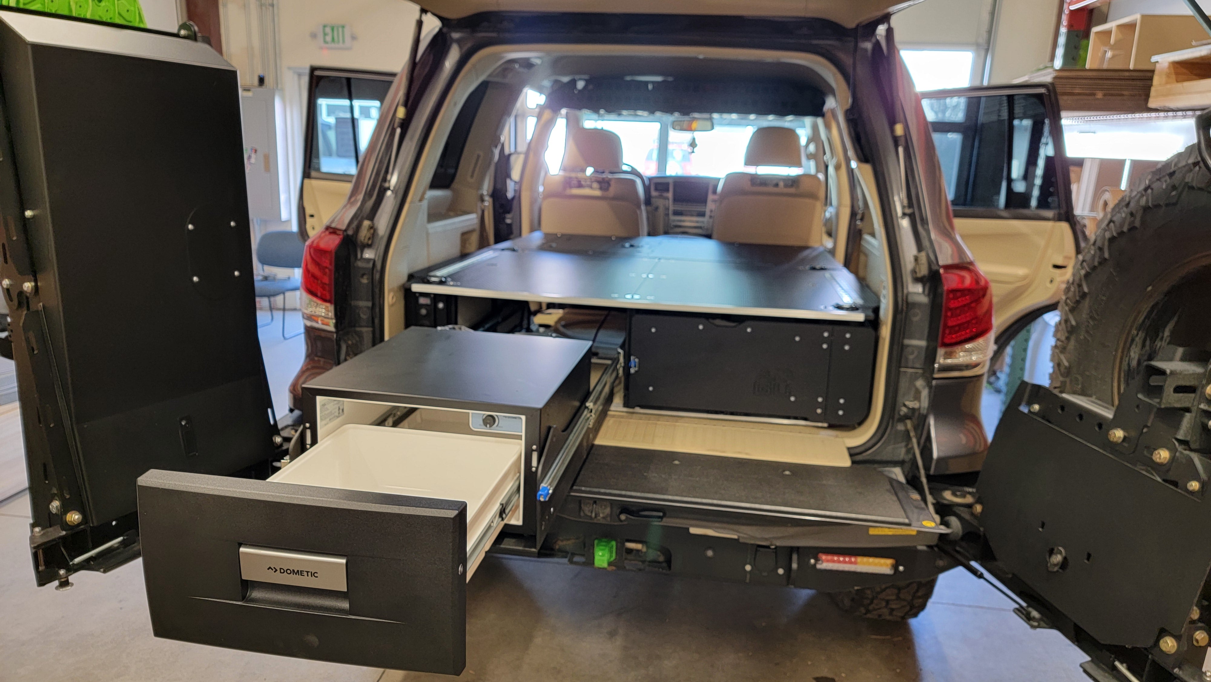 200 Series Toyota Land Cruiser LX570 drawer system with fridge and sleeping platform for vehicle organization perfect for overland travel.