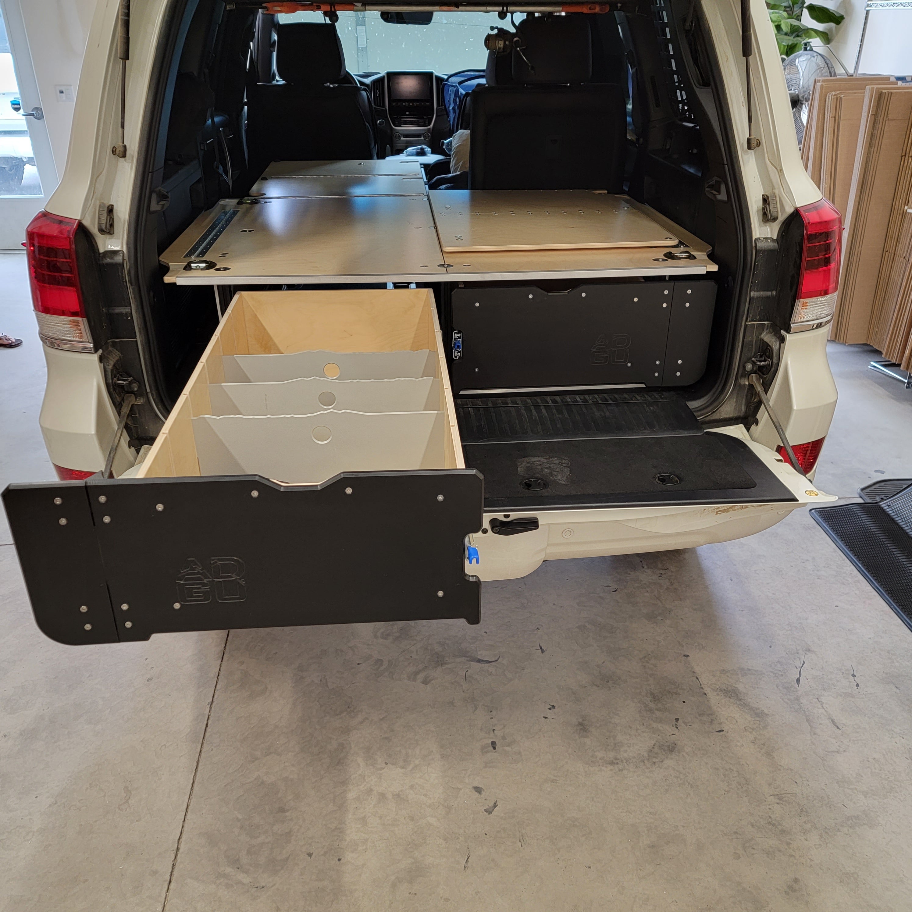 200 Series Toyota Land Cruiser LX570 drawer system with sleeping platform for vehicle organization. This set up includes a 60% Seat Delete frame